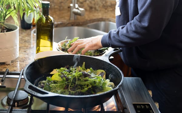 Greens cooking in a pan.
